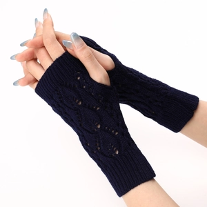 Macro detail of navy blue fingerless knit gloves with hollow leaf pattern and ribbed cuffs