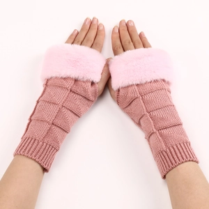Detail of pink knit fingerless gloves with soft faux fur trim and block pattern