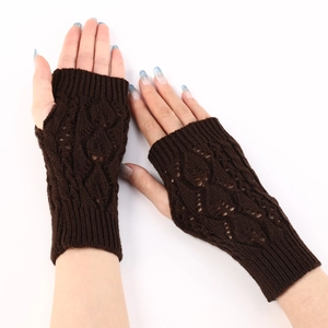 Detailed knit texture of dark brown fingerless gloves with hollow diamond pattern