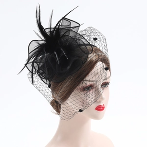 Vintage black feather fascinator with mesh veil and polka dots for bridal weddings
