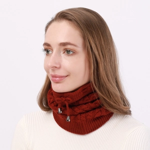 Detail of reddish-brown cable knit neck warmer with adjustable drawstrings and metal buckles