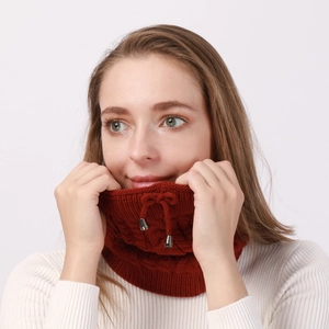 Detail of dark red cable-knit neck warmer with adjustable drawstring and metal buckle