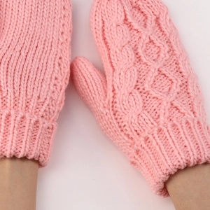 Primer plano de mitones rosas de punto de ochos con textura de lana y puños elásticos