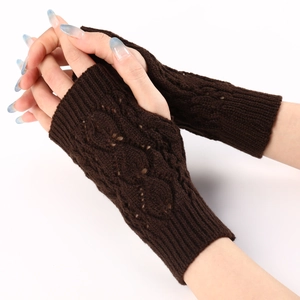 Close-up of dark brown knit fingerless gloves featuring classic cable stitch pattern