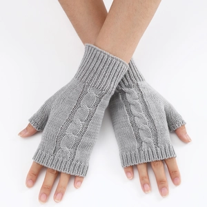 Macro detail of grey cable knit fingerless gloves with ribbed cuffs and soft texture