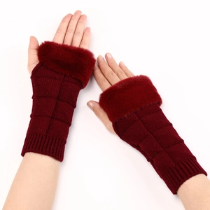 Close-up of knit fingerless gloves in burgundy with plush faux fur trim and textured grid