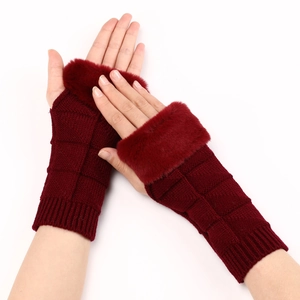 Detail of burgundy knit fingerless gloves with faux fur trim and textured check pattern