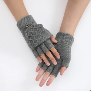 Detailed close-up of grey knitted fingerless gloves with rhombus pattern and button