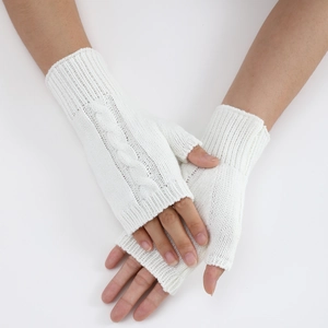Detail of white cable knit fingerless gloves showing woven texture and wrist length