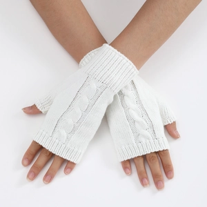 Detailed cable knit pattern on white fingerless gloves and knitted arm warmers