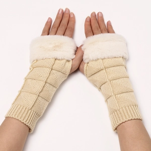 Detail of cream cable knit fingerless gloves with soft white faux fur trim for women