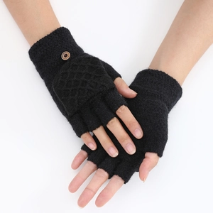 Detail of black knit flip-top gloves featuring a diamond pattern and a brown fashion button