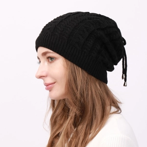 Close-up of black cable knit hat featuring thick warm fleece lining and drawstring detail