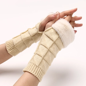 Detailed close-up of cream knit fingerless gloves with soft faux fur trim and texture