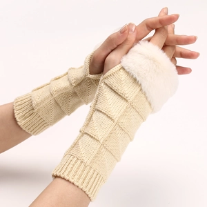 Detail of beige knit fingerless gloves featuring faux fur trim and textured grid pattern