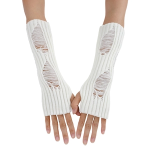 Close-up of white knitted arm warmer featuring distressed hole design and thumb hole