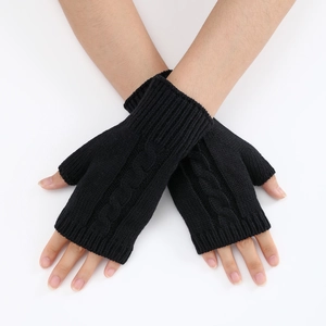 Macro detail of black cable knit arm warmers with fingerless design and ribbed cuffs