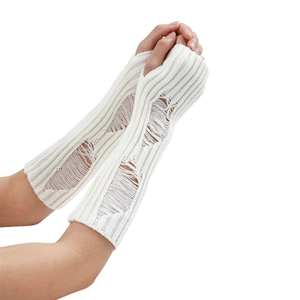 Detail of white knitted arm warmers with distressed hole design and ribbed texture