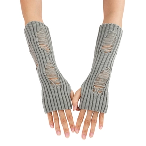 Detail of grey distressed knit arm warmers with hole design and ribbed texture