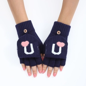 Détail de mitaines en tricot bleu marine avec cœur rose et bouton en bois de fixation