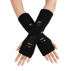 Close-up of black ripped knit arm warmers with distressed gothic cutout details
