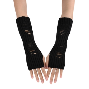 Detail of black knit arm warmer featuring distressed ripped holes and ribbed texture