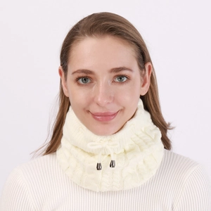 Detail of cream cable knit texture with adjustable drawstring and silver metal toggle