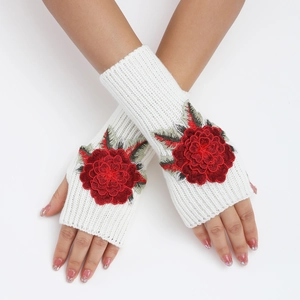 Gros plan de mitaines en tricot blanc avec broderie de rose rouge sur le dos