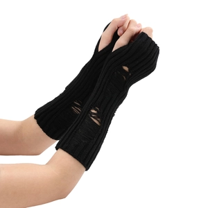 Detail of black distressed knit arm warmer featuring stylish ripped holes and ribbed texture