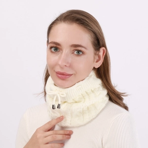 Close-up of beige cable knit neck warmer with adjustable drawstring and metal tips