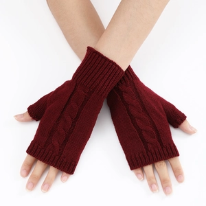 Macro shot of burgundy cable knit arm warmers and fingerless gloves with texture
