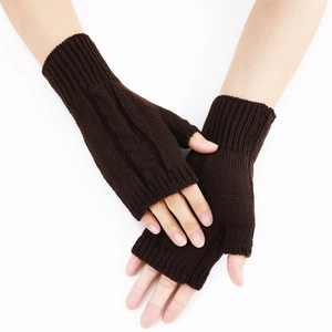 Close-up of dark brown cable knit texture on warm fingerless knitted gloves