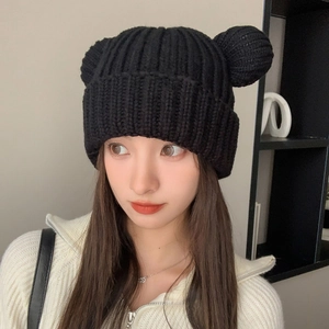 Detail of black chunky knit beanie with cute bear ears and thick ribbed texture design