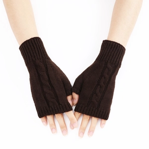 Detailed knit texture of coffee brown cable knit fingerless gloves for winter