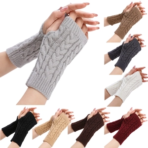 Detail of cable knit fingerless gloves showing various colors and textured weave