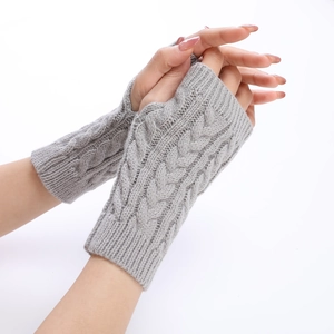 Close-up of grey cable-knit arm warmers showing soft knit texture and fingerless design