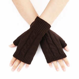 Detail of coffee brown cable knit fingerless gloves showing thick textured weave