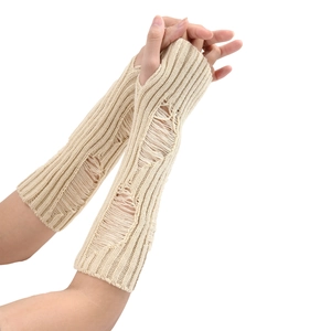Close-up of beige knit arm warmers with distressed hole details and thumb holes