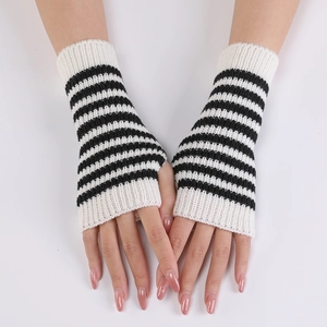 Detailed close-up of knitted black and white striped fingerless gloves on hand