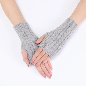 Detail of grey cable-knit arm warmers showing thumb hole and soft ribbed texture