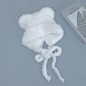 Close-up of white plush cat ear hat with soft faux fur texture and long tie straps