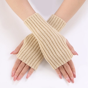Detailed view of beige ribbed knit fingerless gloves with elastic arm warmer texture