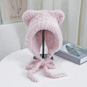 Macro detail of plush pink cat ear knit hat with thick warm faux fur texture and long straps