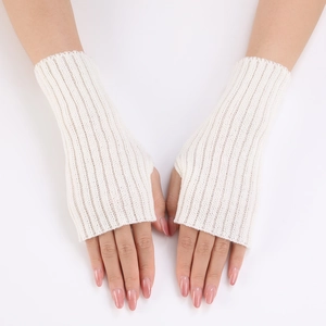 Close-up of white ribbed knit fingerless gloves featuring integrated thumb hole openings