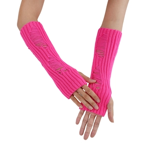 Close-up of neon pink knitted fingerless gloves with distressed hole design