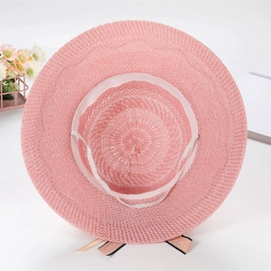 Pink foldable woven sun hat for women with ribbon bow detail and UV protection
