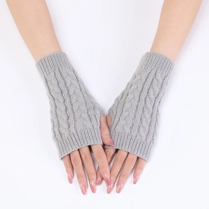 Close-up of grey cable-knit fingerless gloves with thumb hole for winter warmth