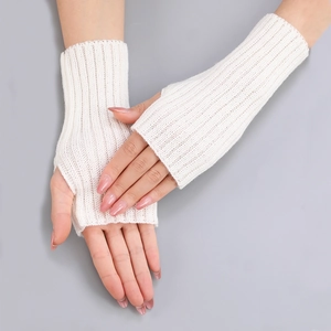 Detailed view of white knitted fingerless gloves with vertical ribbed texture and thumb hole