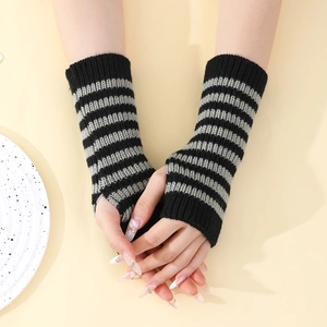 Detailed knit texture of grey and black striped fingerless gloves for winter