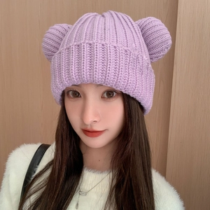 Close-up of lavender knit beanie with bear ears featuring ribbed texture and soft fabric